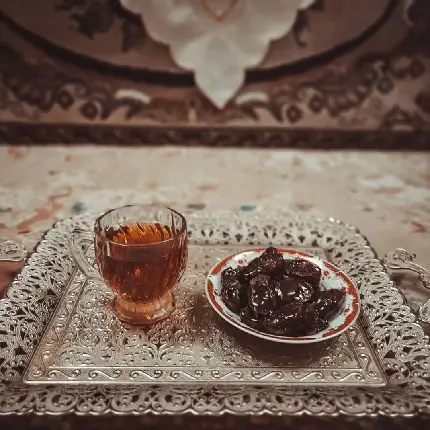 عکس خرما به همراه یک لیوان چای داغ