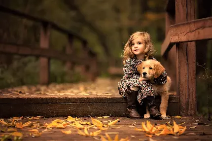تصویر بک گراند باکیفیت از دختربچه شیرین با توله سگش در آغوش