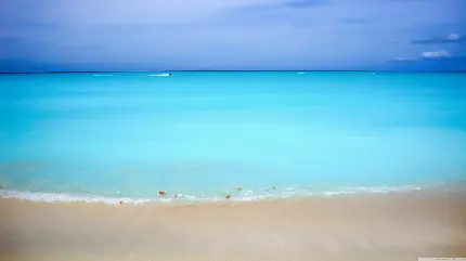 عکس ساحل و شن های داغ با دریای آبی رنگ دلنشین