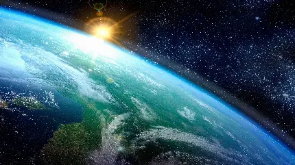 عکس زمینه طلوع خورشید بر روی زمین در فضا