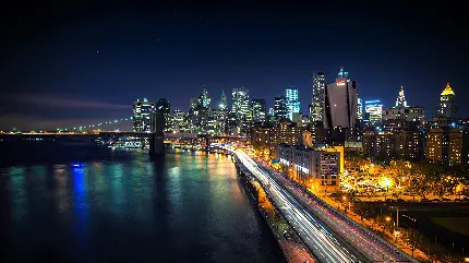 دانلود عکس پروفایل شهری وسیع با نور زیاد در شب در کنار رودی بزرگ