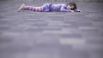 والپیپر خاص از دختر بچه دراز کشیده روی زمین با لباس بنفش 