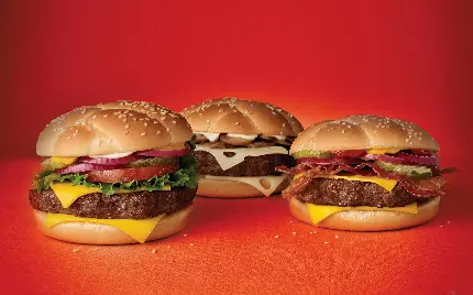 بک گراند سیستم با طرح سه همبرگر خوشمزه با زمینه قرمز