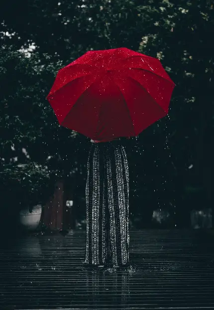 دانلود پوستر فانتزی دختری چتر قرمز رنگ در باران واقعی و در کنار درختی بزرگ