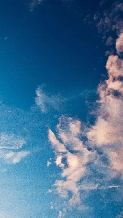 تصویر زمینە نچرال خاص موبایل از آسمانی با ابرهایی پراکندە در سمت راست باکیفیت بالا