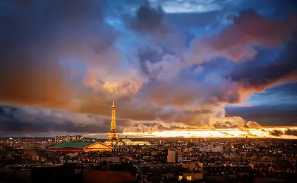 والپیپری از نمای دور از شهر پاریس کشور فرانسە و نماد فرهنگ در شب مشکی با ابرهای مشوش