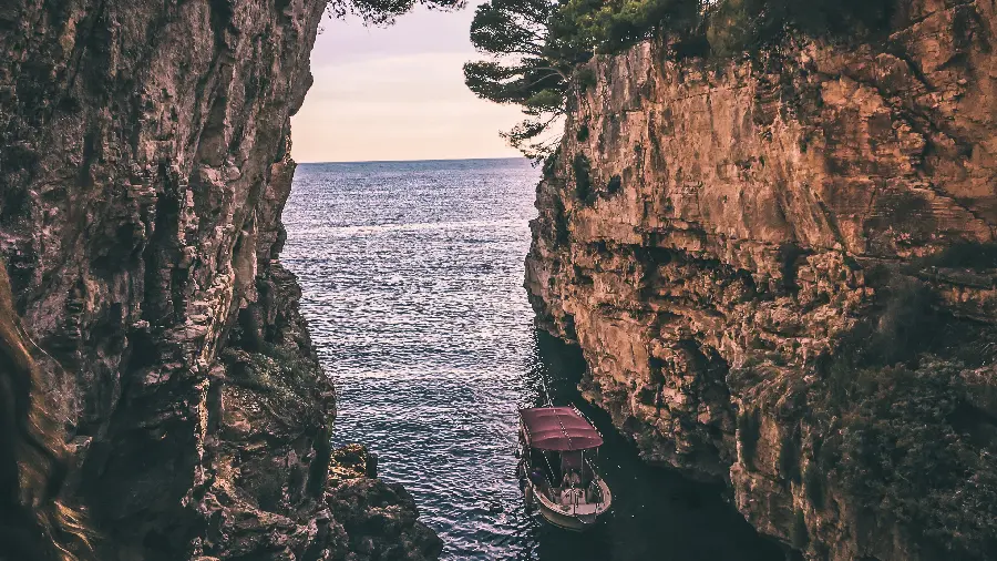 پست هنری قایق کوچک میان دو صخره در دریا برای instagram