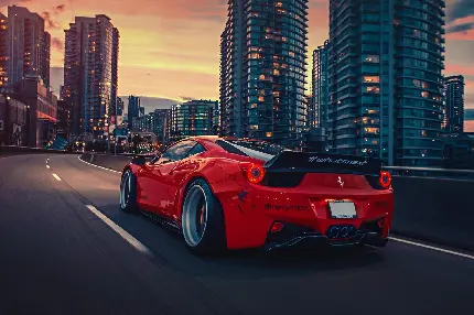عکس جالب و دیدنی از ماشین قرمز در جاده با ساختمان های بلند کنار جاده 