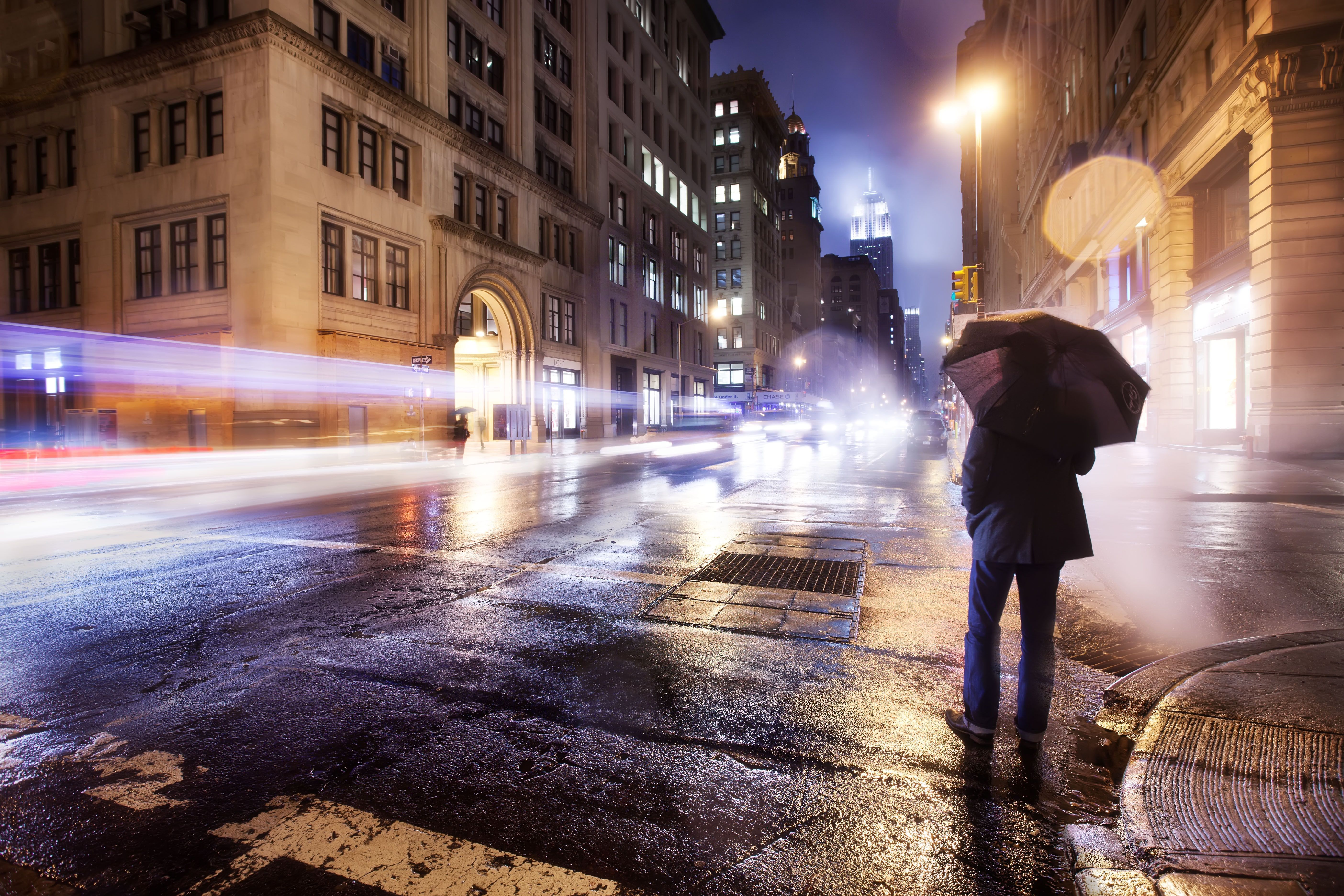 عکس پربیننده از مرد تنها در شهر بزرگ زیر باران شبانه