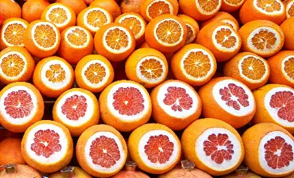 بک گراند تماشایی از چیدمان گریپ فروت های قرمز و پرتقال