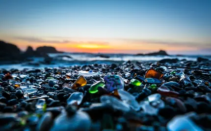 عکس استوک سنگ های شفاف در کنار ساحل هنگام غروب با کیفیت بالا