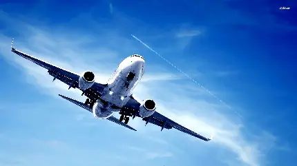 عکس زمینه چشم نواز پرواز هواپیمای مسافربری سفید در آسمان آبی