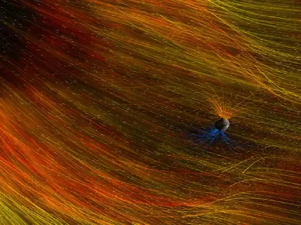 عکس ترسیمی میدان های مغناطیسی اطراف سیاره زمین با خطوط رنگی