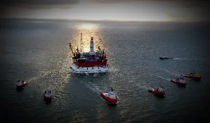 تصویر زمینه پرابهت قایق های در حال حرکت به سوی سکوی نفتی 