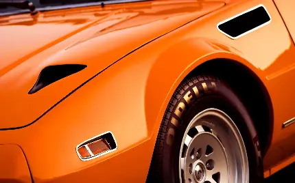 نمایه ای نزدیک از ماشین نارنجی با رینگ های شیک نقره ای