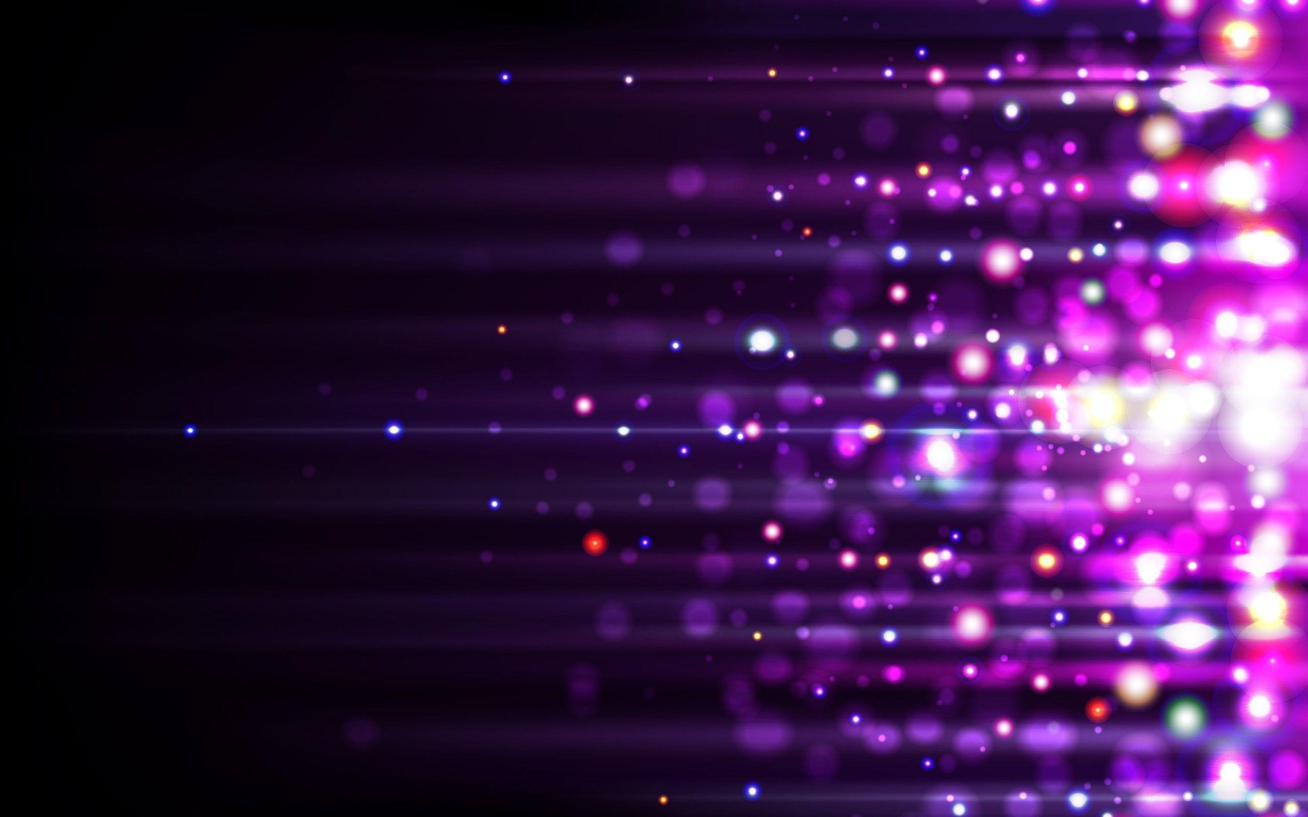 تصویر زمینه از ذرات نورانی با لکه های درخشان رنگارنگ در زمینه مشکی در قالب های رمانتیک