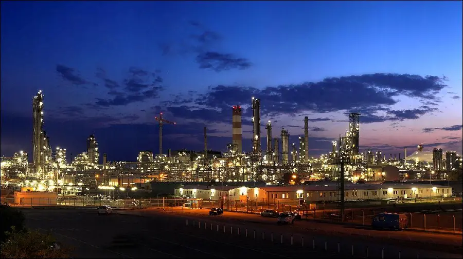 تصویر پالایشگاه نفت درخشان و پر نور در غروب آرامش دهنده